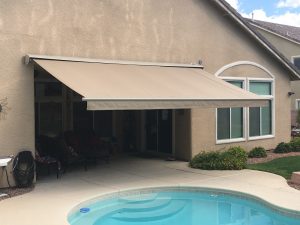 A retractable awning over a pool deck.