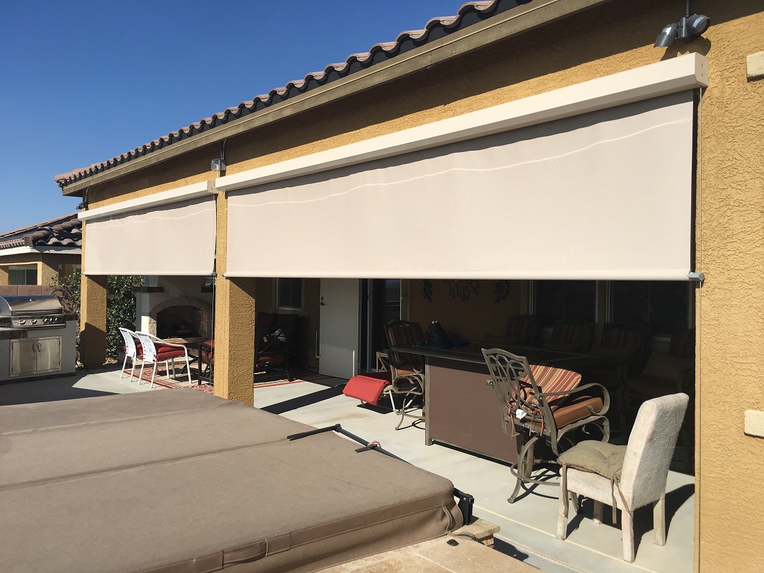 A patio cover with retractable screens for adjustable shade.