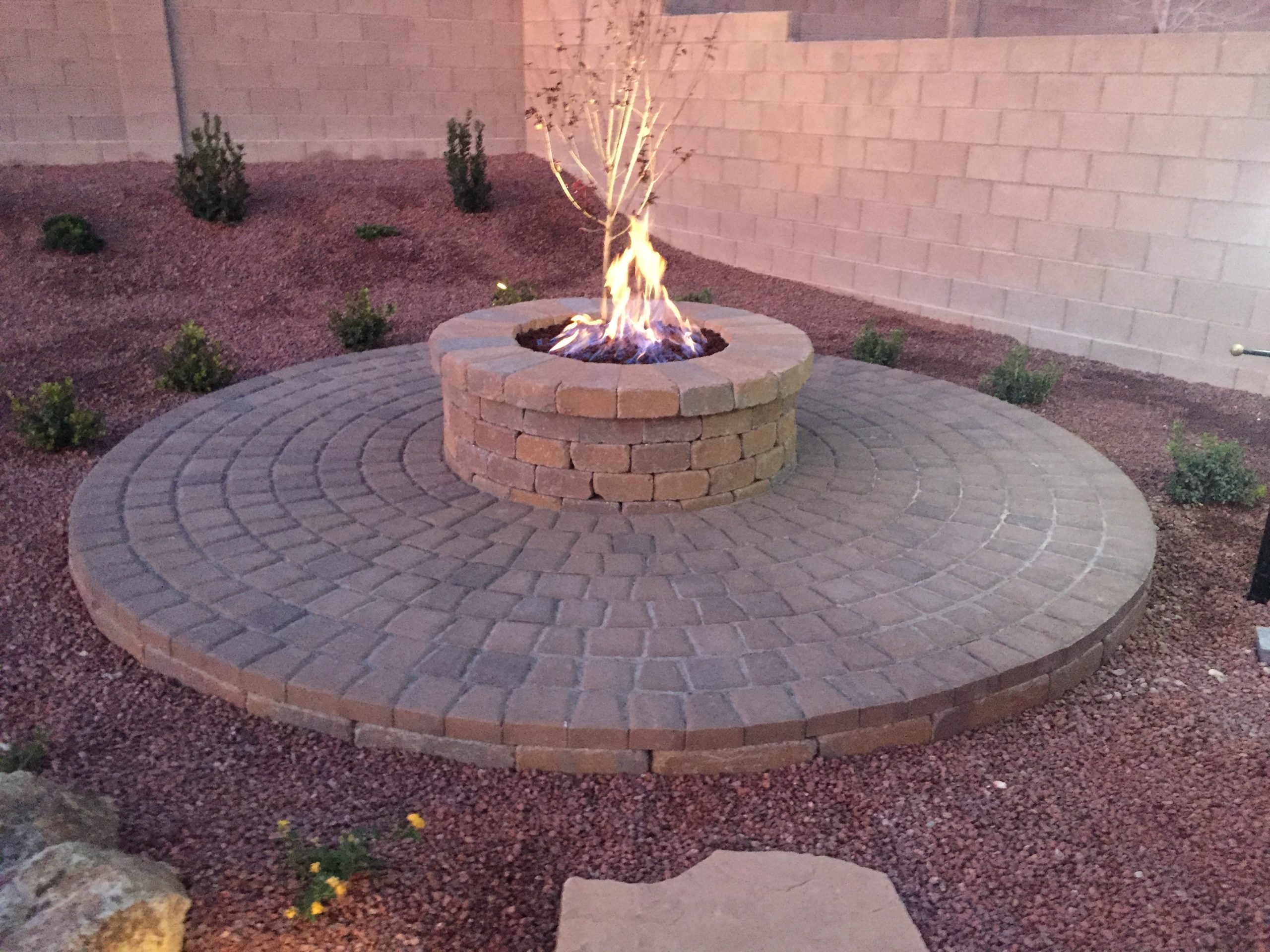A custom fire pit atop a paved patio.