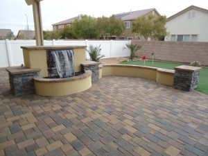 Picture of a beautiful new paver patio with a fountain and seating.