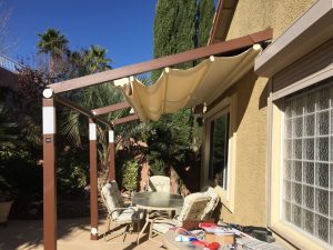 Picture of a retractable awning attached to the side of a house.