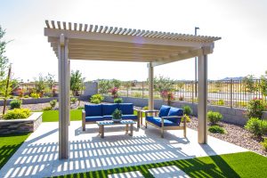 Rear Yard Pergola Covering Coffee Table &amp; Two Couches With Blue Cushions